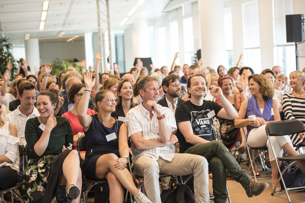 Een zaal vol enthousiaste deelnemers