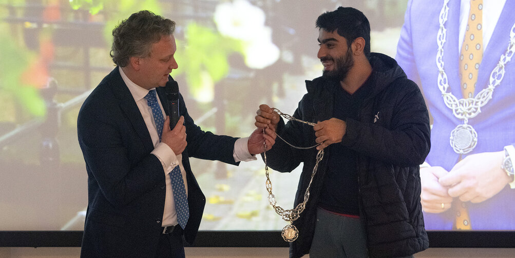 Een van de deelnemende studenten opent samen met de burgemeester officieel het lab.